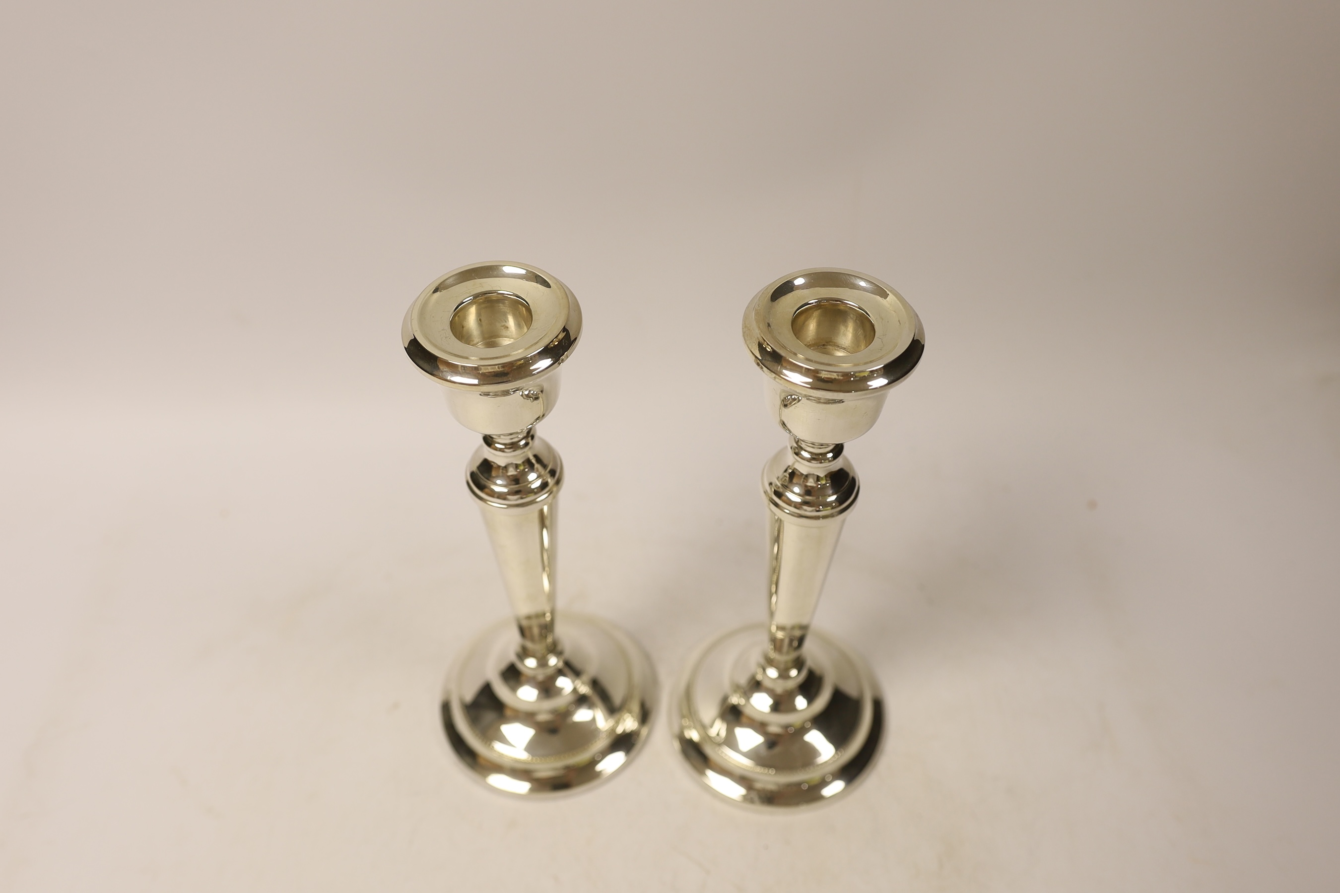 A pair of Elizabeth II silver mounted candlesticks, Birmingham, 1967, 21.5cm, weighted.